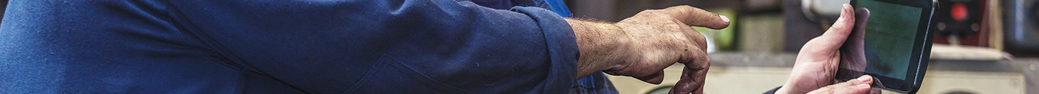 'challenges we ran into' section header image - picture of workers' hands pointing at a tablet